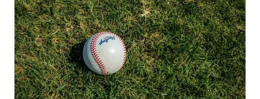 baseball ball on a grass field and what is baseball