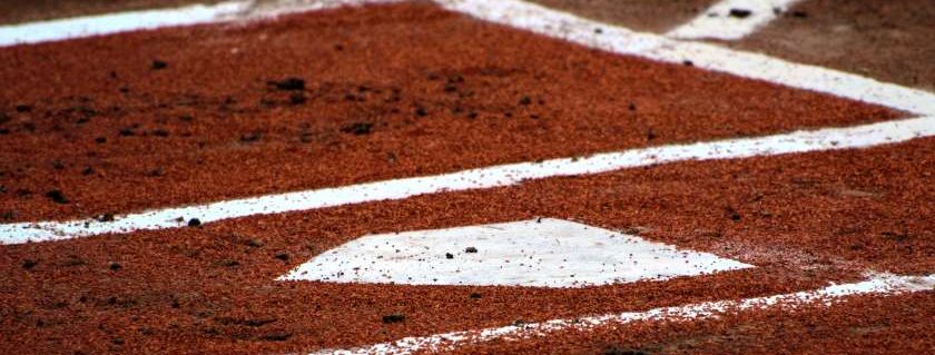 brown ground with white lines and baseball field